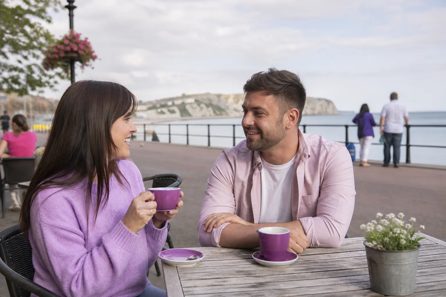 Two people talking over coffee in a South East England town centre